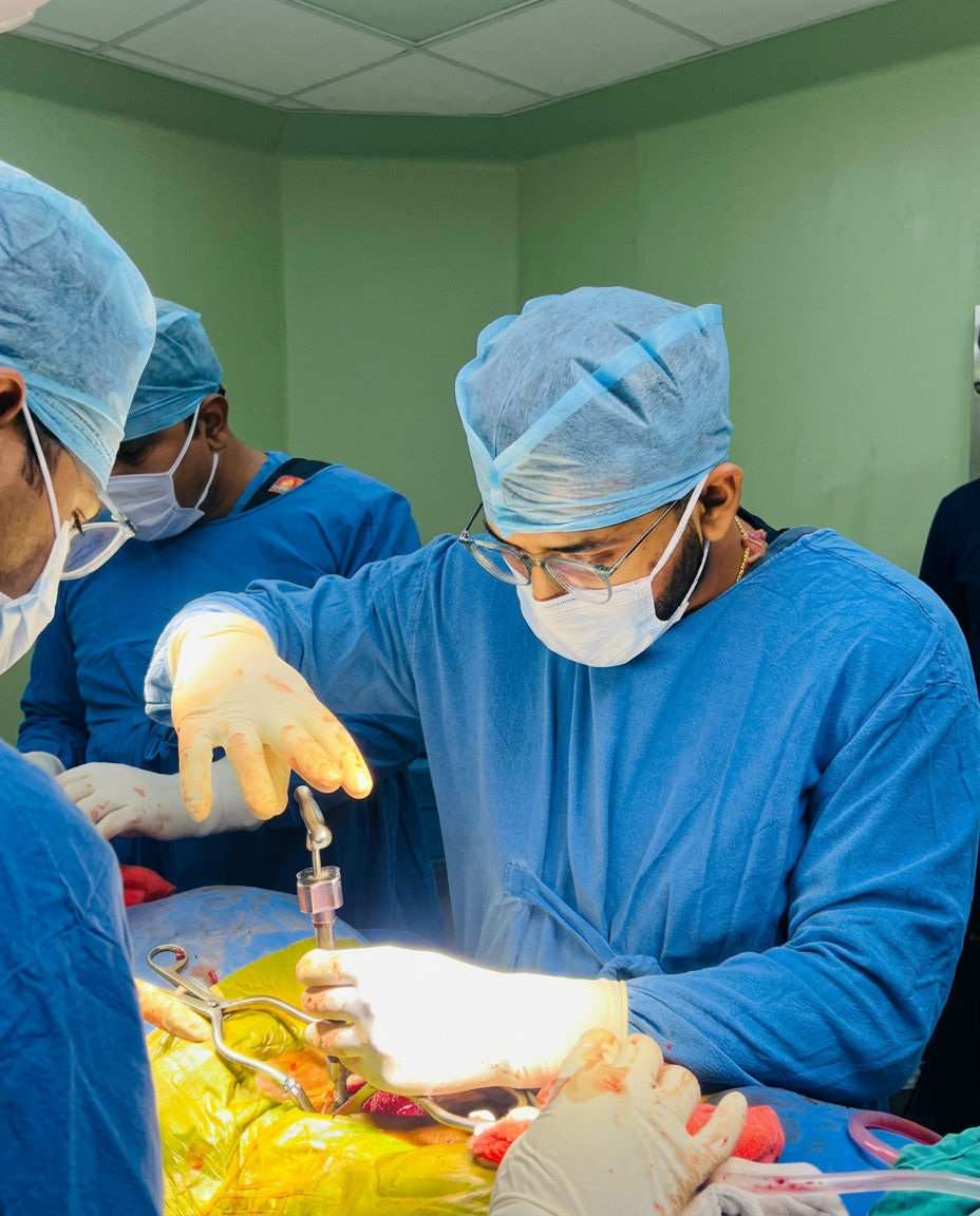 Dr. Naman Parakh performing surgery in blue scrubs